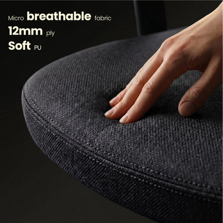 Hand touching a black cushion with text about micro breathable fabric and soft PU.